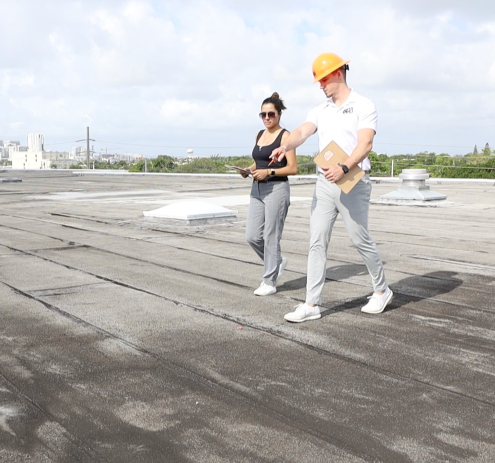 Sales representative inspecting roof