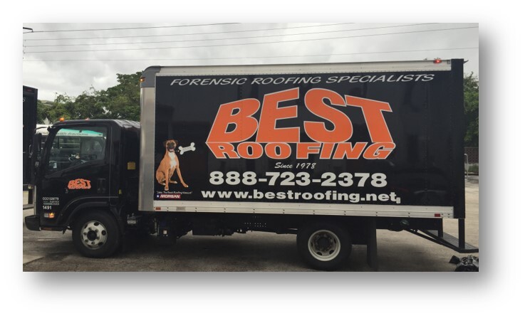 Black service truck with advertising for Best Roofing parked outside a building.